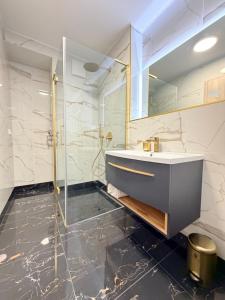 a bathroom with a sink and a shower at GG Apartment 7 in Garmisch-Partenkirchen +10 photos