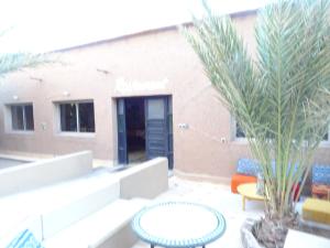a patio with a table and chairs and a building at PALM'SKOURA in Skoura +61 photos