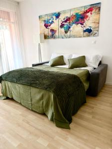 a bedroom with a bed and a painting on the wall at Ale’s House in Venice-Lido
