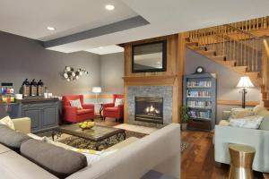 a living room with a couch and a fireplace at AmeriVu Inn & Suites - Shakopee in Shakopee
