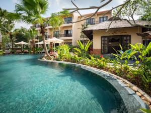 a swimming pool in front of a hotel at La Lua Resort Ninh Binh in Ninh Binh
