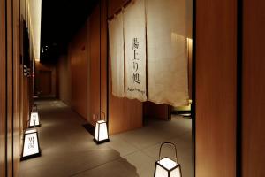a hallway with lights on the floor of a building at Candeo Hotels Osaka Namba in Osaka
