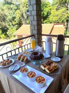 a table with different types of pastries on it at Pousada Flor do Café in Ubajara