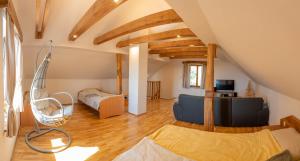 a living room with a bed and a couch at Vineyard cottage Mehak in Telče