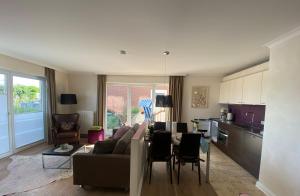 a kitchen and living room with a couch and a table at Strandhaus Haffkrug in Scharbeutz