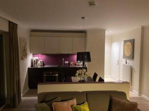 a kitchen and living room with a couch and a table at Strandhaus Haffkrug in Scharbeutz
