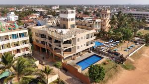 an aerial view of a city with a building and a pool at Atarah Beach Hotel in Negombo