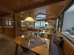 a dining room with tables and chairs in a restaurant at Gasthaus Pension Augenstein in Winzer
