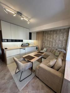 a living room with a couch and a table at Forum Apartment in Stara Zagora