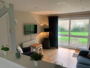 a living room with a large sliding glass door at Seabrook Lodge in Newquay