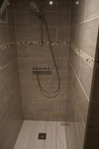 a shower with a hose in a bathroom at Studio - Free Parking - Netflix - Wi-Fi in Brive-la-Gaillarde