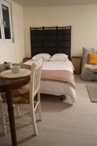 a bedroom with a bed and a table with a bowl on it at Studio - Free Parking - Netflix - Wi-Fi in Brive-la-Gaillarde