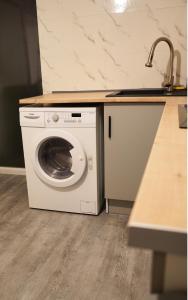 a washing machine in a kitchen with a sink at Studio - Free Parking - Netflix - Wi-Fi in Brive-la-Gaillarde