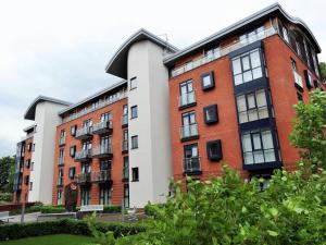 an apartment building with red and white at Solihull Centre Apartments in Solihull
