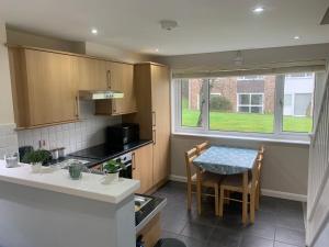 a kitchen with a table and a small table and chairs at Seabrook Lodge in Newquay