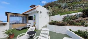 a patio with two chairs and a table on a house at Terrazas de Anaga Playa in Santa Cruz de Tenerife