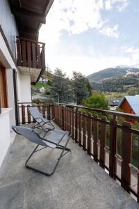 two chairs on a balcony with a view of a mountain at Chalet Beppe in Bormio