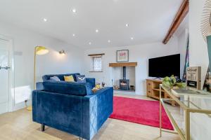 a living room with a blue couch and a tv at 2 Bed in Hunningham oc-h34740 in Bubbenhall