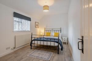 a bedroom with a bed with yellow pillows and a window at 2 Bed in Hunningham oc-h34740 in Bubbenhall