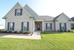 a house with a grassy yard in front of it at Desoto Rental in Olive Branch
