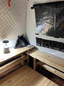 a room with two wooden benches and a bag on it at 川辺の宿-Kawabe-BBQ-川遊び in Hanno