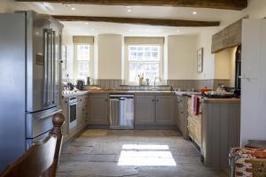 a large kitchen with gray cabinets and appliances at 4 Bed in Middleham oc-c34754 in Caldbergh