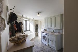 a kitchen with a sink and a washing machine at 4 Bed in Middleham oc-c34754 in Caldbergh