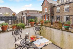 a table with a bowl of fruit on a balcony at 2 Bed in Lynton oc-s33456 in Lynmouth