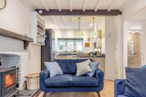 a blue couch in a living room with a fireplace at 2 Bed in Lynton oc-s33456 in Lynmouth