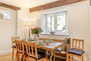 a dining room with a wooden table and a window at 2 Bed in Lynton oc-s33456 in Lynmouth +23 photos