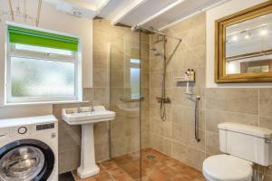 a bathroom with a shower and a toilet and a sink at 2 Bed in Lynton oc-s33456 in Lynmouth