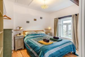 a bedroom with a bed with a blue comforter at 2 Bed in Lynton oc-s33456 in Lynmouth