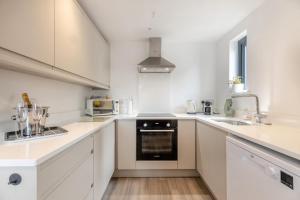 a kitchen with white cabinets and a stove top oven at 2 Bed in Holt oc-l31797 in Holt