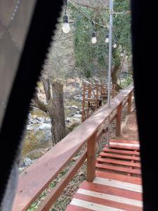 a wooden bridge with stairs leading to a river at 川辺の宿-Kawabe-BBQ-川遊び in Hanno