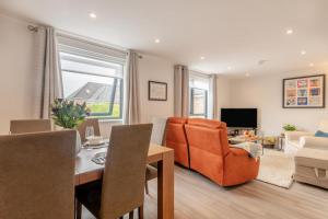 a living room with an orange chair and a couch at 2 Bed in Holt oc-l31797 in Holt