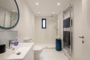 a white bathroom with a toilet and a mirror at 2 Bed in Holt oc-l31797 in Holt +13 photos