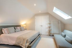 a bedroom with a bed and a couch at 2 Bed in Holt oc-l31797 in Holt