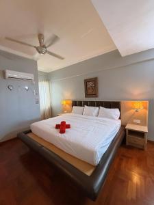 a bedroom with a bed with a red stuffed animal on it at Roamia Retreat - Lighthouse in Langkawi Islands
