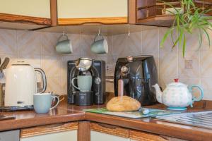 a kitchen counter with various appliances on a counter top at 2 Bed in Trefil oc-n34478 in Nant-y-bwch