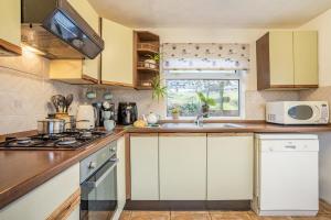 a kitchen with white cabinets and a sink at 2 Bed in Trefil oc-n34478 in Nant-y-bwch