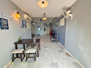 a dining room with a table and chairs in a room at Roamia Retreat - Lighthouse in Langkawi Islands