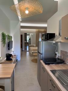 a kitchen and living room with a couch in the background at Suites Domus Fysi in Palermo