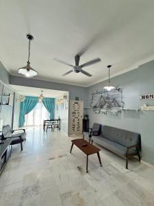a living room with a couch and a table at Roamia Retreat - Lighthouse in Langkawi Islands