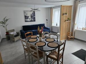 a living room with a table and chairs at Gîte de la Tour d'horloge in Carvin +16 photos