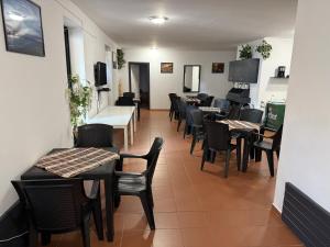 a restaurant with tables and chairs in a room at Beach Hostel Balatonboglár in Balatonboglár