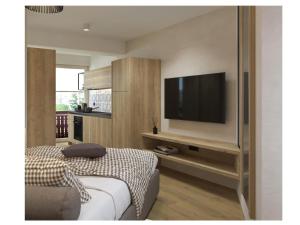 a bedroom with a bed and a television on a wall at Golf Apartments in Kranjska Gora
