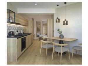 a kitchen and dining room with a table and chairs at Golf Apartments in Kranjska Gora