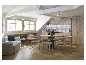 a living room with a couch and a table and chairs at Golf Apartments in Kranjska Gora +10 photos