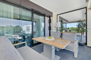 a dining room with a table and chairs at Baltic Infinity Garden Suite 316 - SPA & Pool Access in Międzyzdroje