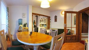 a dining room with a wooden table and chairs at PORTALA Urban Lodge in Rila